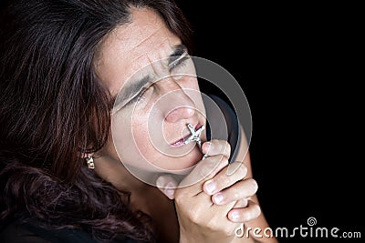 Emotional portrait of an hispanic woman praying