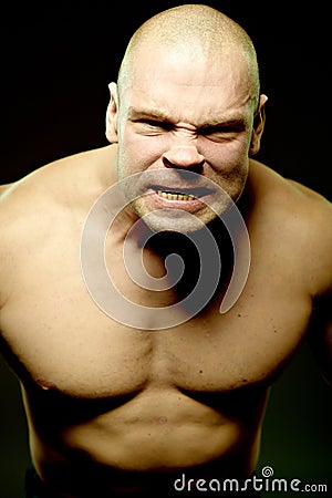 Emotional portrait of muscular aggressive man