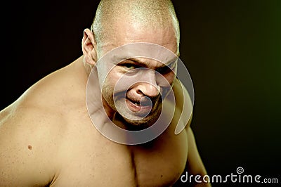 Emotional portrait of muscular aggressive man