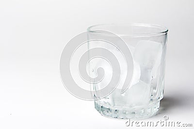 Empty glass with ice cubes