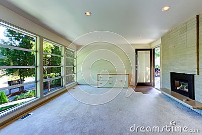 Empty house interior. Glass wall living room with brick wall an