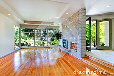 Empty house interior. Living room with glass wall and brick wall