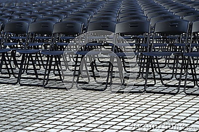 Empty plastic seats in public square