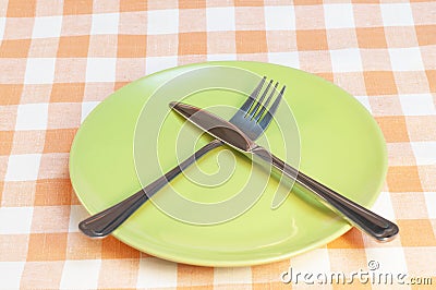 Empty plate with fork and knife