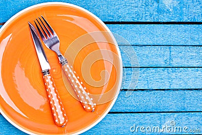 Empty plate and fork, knife
