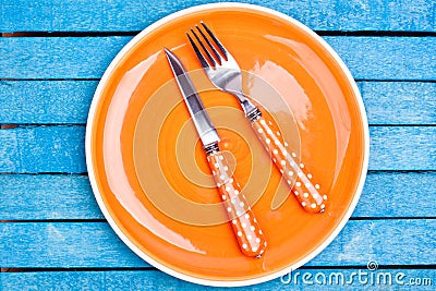 Empty plate and fork, knife