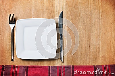 Empty plate with fork and knife, table arrangement