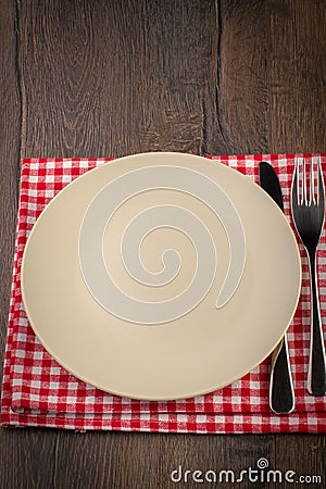 Empty plate on wooden table