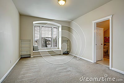 Empty room with arch window and bench