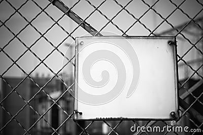 Empty white metal board on the fence