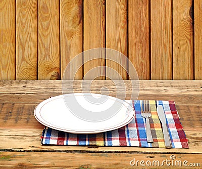 Empty white plate with fork and knife