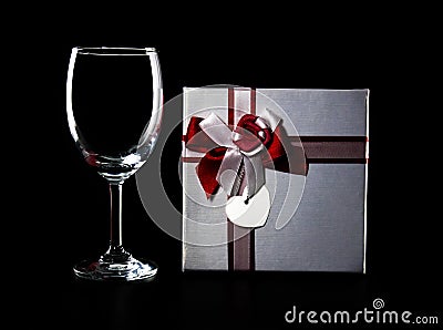 Empty wine glass and present