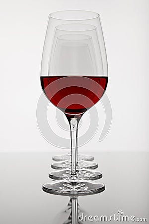 Empty wine glass with reflection on white