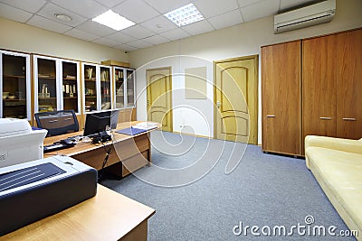 Empty working area with desktop, bookcase in modern office