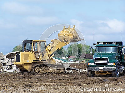 End loader loading dirt into dump truck