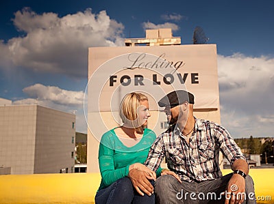 Engaged couple with love sign