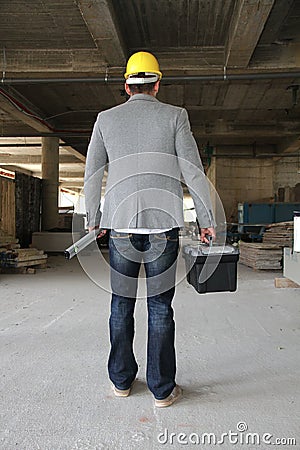 Engineer at a construction site making a business call