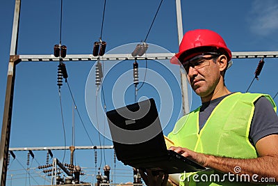 Engineer Using Laptop at an Electrical Substation.