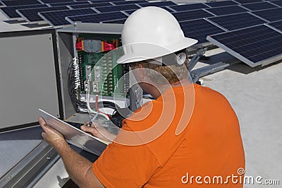 Engineer Writing Notes While Analyzing Electricity Box