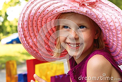 Enthusiastic girl in elegant hat