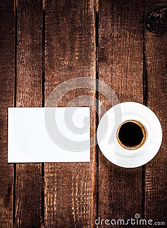 Espresso Coffee cup and blank business card on wooden table. Whi