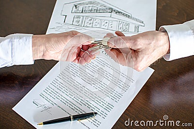 Estate agent giving house keys to customer