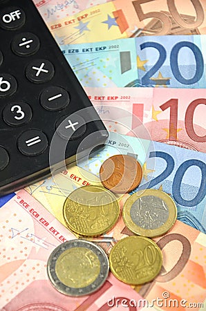Euro banknotes, coins and calculator