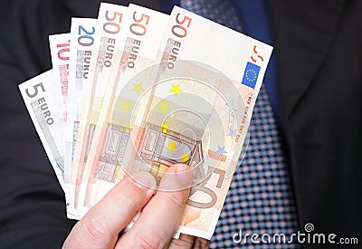 Euro banknotes in male hand