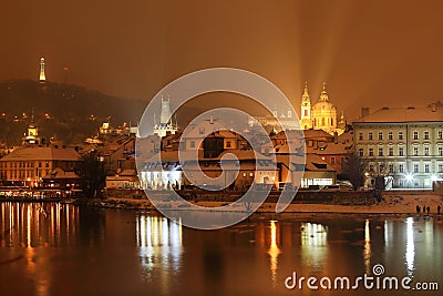 Evening romantic snowy Prague Lesser Town above River Vltava with Hill Petrin, Czech republic