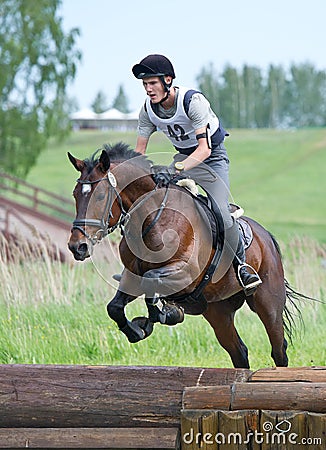 Eventer on horse is Drop fence in Water jump