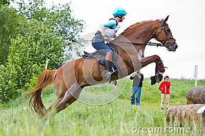 Eventer on horse is jump the cross-country fence