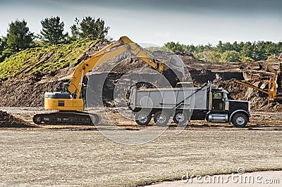 Excavator loading dumper truck