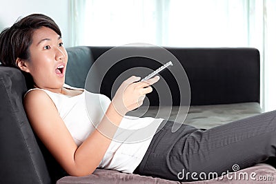 Excited Asian woman executive watching television