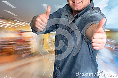 Excited young man gesturing thumbs up