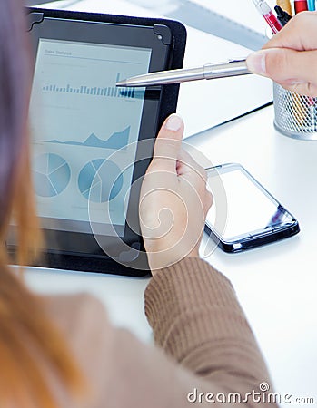 Executive hands with digital tablet in a financial meeting