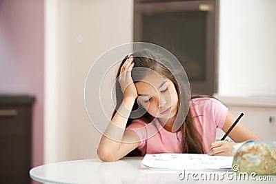 Exhausted little girl studying