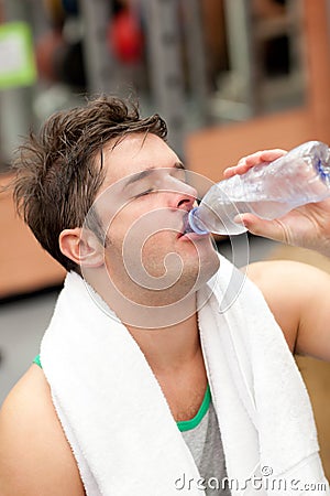 Exhausted man drinking water