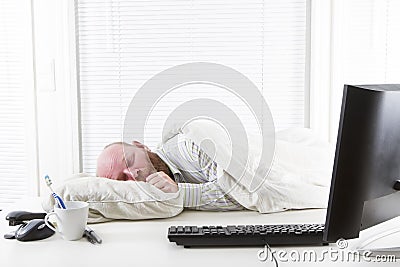 Office worker Sleeps on his Desk