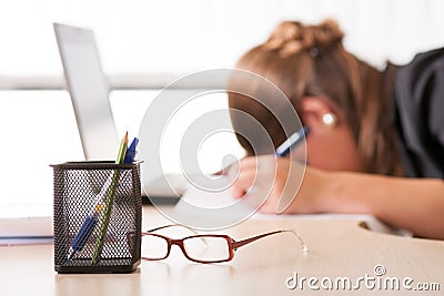 Exhausted woman sleeping at work