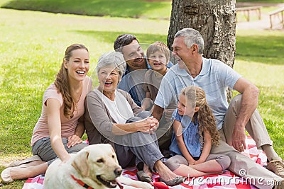 Extended family with their pet dog at park