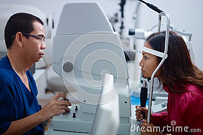 Eyesight exam with Asian doctor and patient