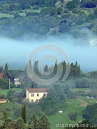 Fabulous landscape of the foggy morning in Tuscany.