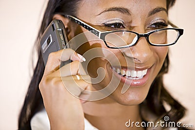 Face of pretty African-American woman on phone