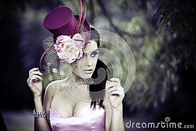 Face of young beautiful woman in a vintage hat