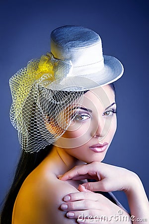 Face of young beautiful woman in a vintage hat