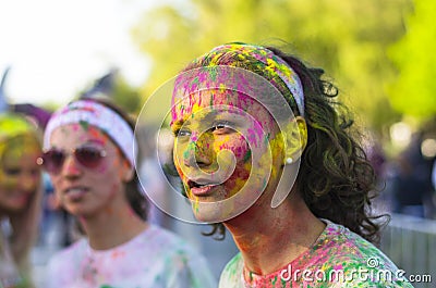 Face of young woman with colored powder