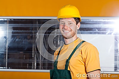 Factory worker in overalls and hardhat