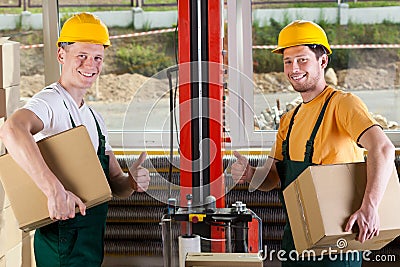 Factory workers showing thumbs up sign