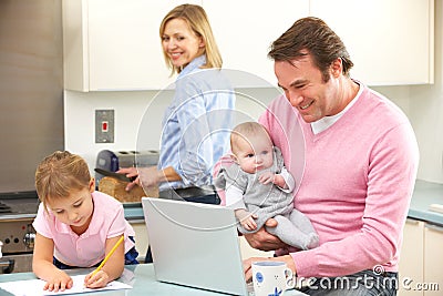 Family busy together in kitchen