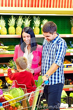 Family buying healthy food in supermarket